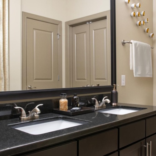 Spacious bathrooms with everything you need a bathroom with a marble countertop and large mirror