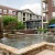 a fountain in a courtyard between buildings