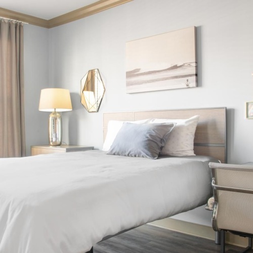 Generous bedroom offerings to fit every family a bedroom with a bed and a chair